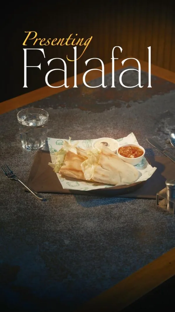 Dish reel: falafel wraps, golden and herby, presented on dark stone.
