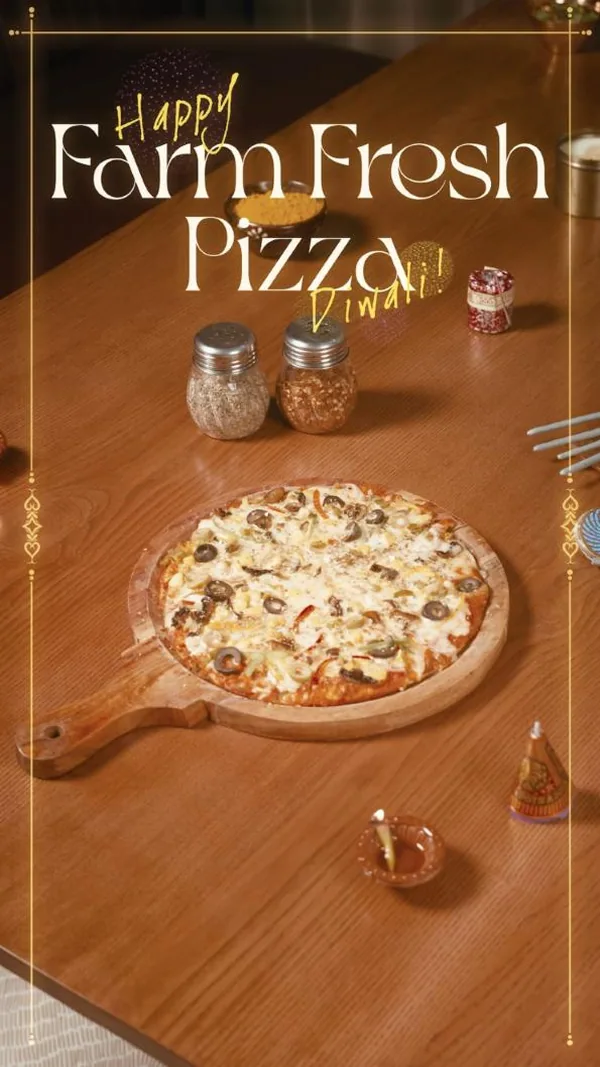 Diwali table: Farm Fresh Pizza among diyas and festive lights.